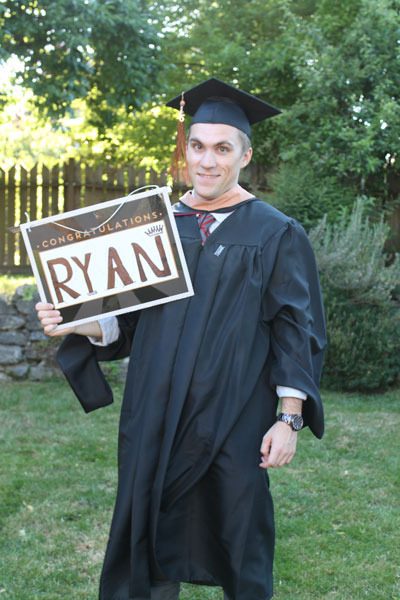 Ryan Rovang holds up a graduation sign after completing his master’s of business administration degree at Seattle University in June.