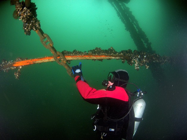 A diver inspects anchor lines that secure the new floats at South Whidbey Harbor. They were installed so they crisscross and rub
