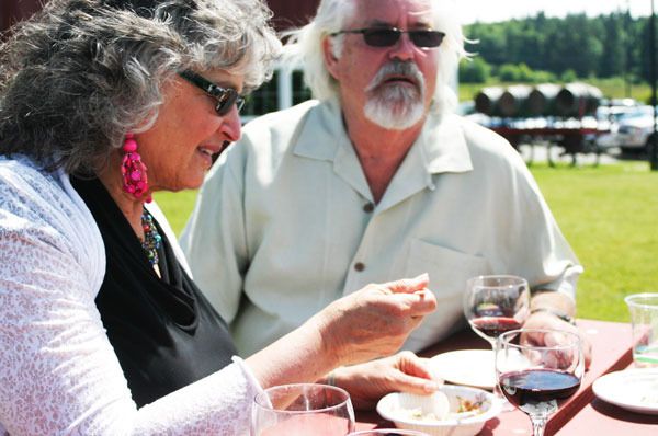 Langley resident Vicki Robin enjoys a few tastes of Whidbey and local wines with friends at last year’s Slow Food Whidbey Island event at Greenbank Farm. This year the Taste of Whidbey takes place at Freeland Hall from 3 to 5 p.m. Sunday