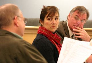 Helen Price Johnson and Langley Mayor Paul Samuelson listen to Commissioner Mac McDowell during the Island County Council of Governments meeting Wednesday.