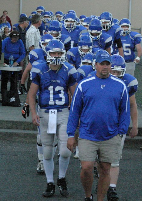 Falcon coach Mark Hodson and the South Whidbey football team enter the stadium to the delight of hundreds of fans on Friday.