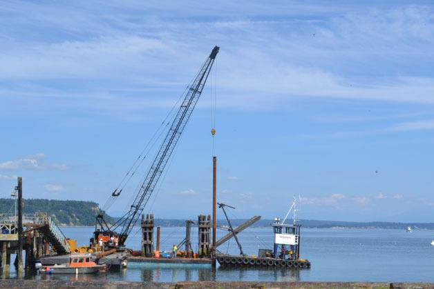 Workers install the subsurface pilings at South Whidbey Harbor at Langley on Monday Aug. 12. The pilings will anchor the new dock to the sea floor.