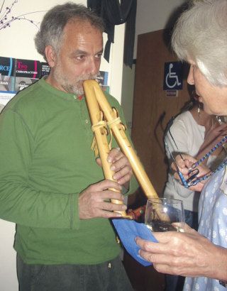 Langley musician Joe Arnold entertains Jeanne Strong of Freeland at a recent charity bash at The Chiropractic Zone in Freeland.