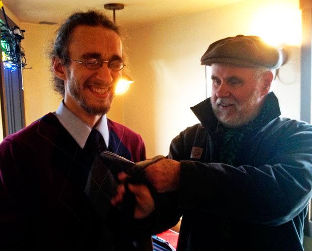 Fred Lundahl ceremoniously cuts the tie of fellow pilot Aaron Simpson.