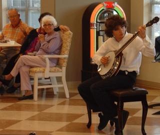 Middle school banjo musician Sean Leisle of South Whidbey plays for the seniors at Maple Ridge Retirement Community in Freeland as part of Youth In Arts happening through April.