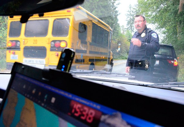 Langley Police Chief Randy Heston waits for traffic to pass after giving a warning to a speeder on Saratoga Road. The city’s 2013  budget is beginning to take shape and the City Council has given the go ahead to hire another officer