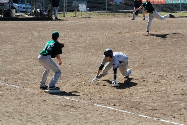 Josiah Sergeant dives back to first base.