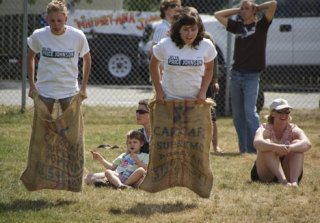 Christine Johnson edges out Cassie Bosman to win the sack race during the games on July 4 at the Maxwelton Parade.