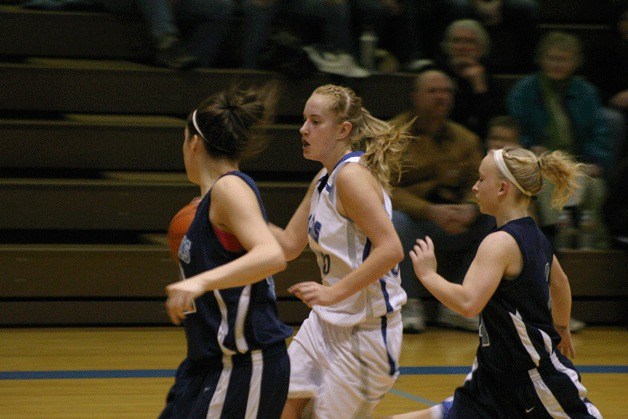 Hayley Newman breaks the Turks’ trap and dribbles past Blakeley Alwood and Randi Tuggle on Friday night. The Falcon junior led all scorers with 19 points.