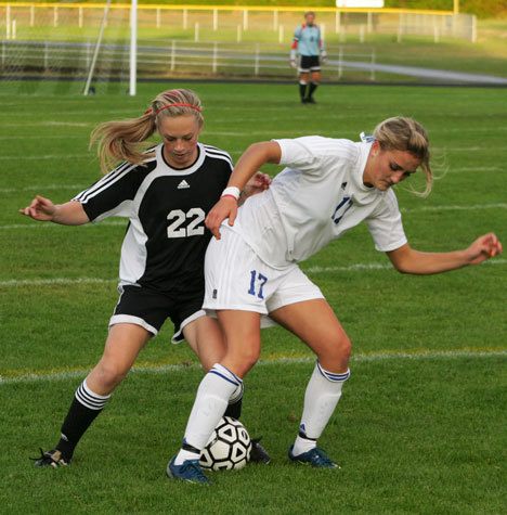 Falcon forward Paige Miller (17) tangles with Wildcat defender Shelby Koch on Monday at Waterman Field. South Whidbey lost the battle 8-0.