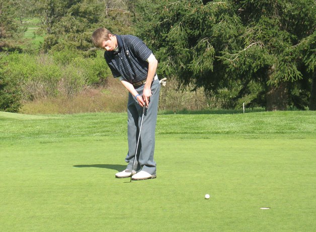 Shane Thompson tracks his putt during South Whidbey's golf match with Cedarcrest and Sultan. Thompson finished in a three-way tie for first place with 67 strokes. The Falcons won the match with 354 combined strokes through 15 holes.