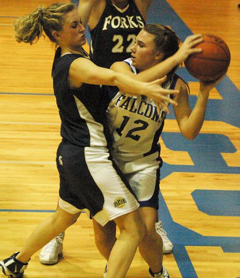 Falcon starter Alannah Alber makes one more desperate attempt to get past Spartan guard Taylor Morris and score during the fourth quarter of Thursday’s 40-30 loss to Forks.
