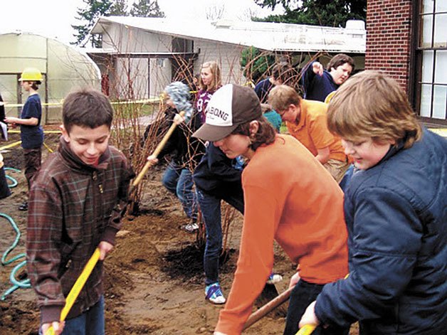 Langley Middle School students prep the school grounds for landscaping plantings.