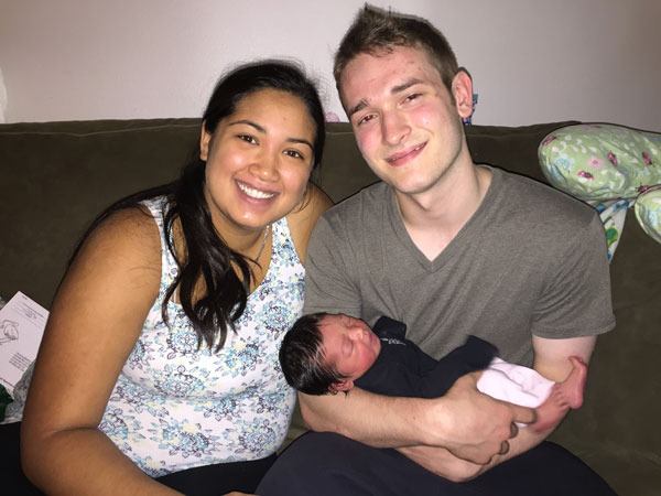 Parents Alyscia Spratt and Isaiah Gardner with their newborn baby