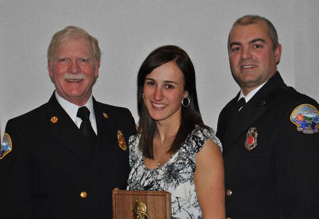 Leah Hughes was named Fire Fighter of the Year and her father Forrest Hughes (right) received the Carl Simmons Award at Saturday’s Island County Fire District 3’s annual awards banquet. With them is Fire Chief Rusty Palmer.