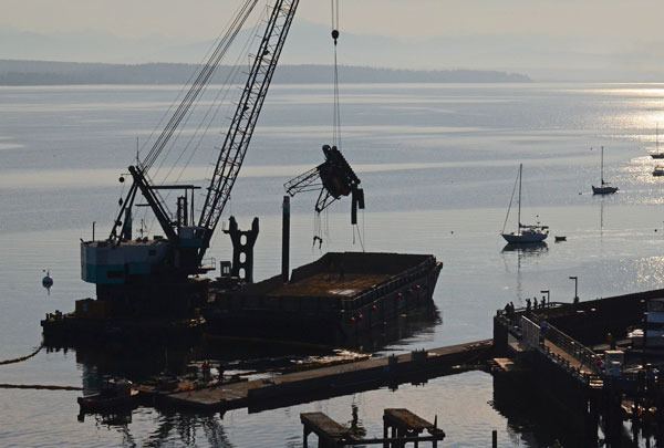 A crane that spent more than one week at the bottom of South Whidbey Harbor is loaded onto a barge Thursday.