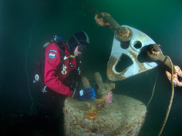 A diver inspects the joint that connects a weight to an anchor line securing South Whidbey Harbor’s new docks to the seafloor.