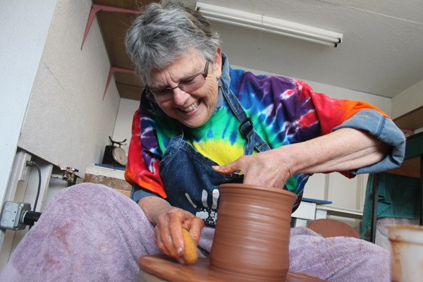 Virginia Rigney works on a clay vase while preparing the pottery shack for the fair.