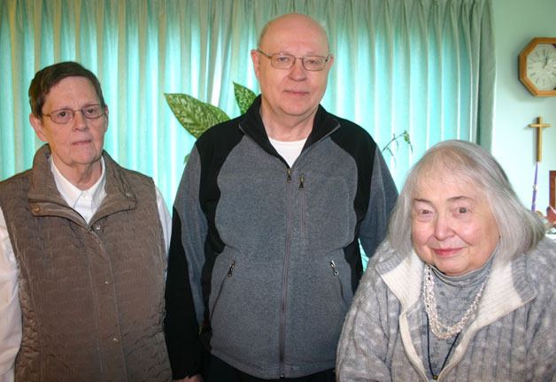 Phil Ayers stands with his wife Amy Ayers (left) and Nan Kent