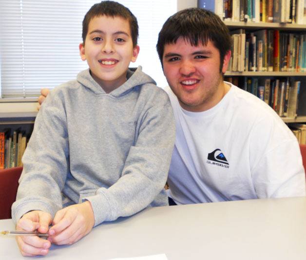 Big Brothers Big Sisters scholarship recipient David Lile sits with his 'little brother.'
