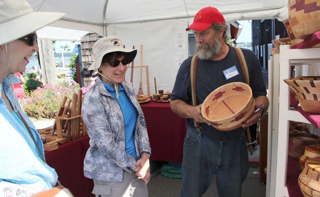 Festival attendees check out a basket at the 2012 Coupeville Arts and Crafts Festival.