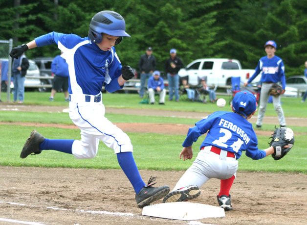 South Whidbey’s Aidyn Frederick beats the throw from Sedro-Woolley third baseman Dylan Zimmerman during the first inning of the District 11 All-Star Tournament.