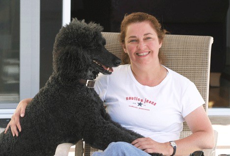 Kelly Scotthanson gets a greeting from her Standard Poodle