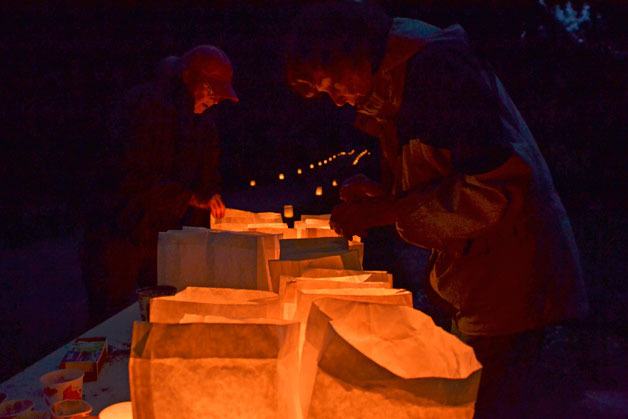 Cary Peterson and Meg Peterson set up luminaries for All Soul’s Eve