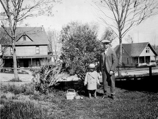 Bill and Stanley Hunziker stand in front of the McLeod House in 1926. The Howard Hotel is at left.