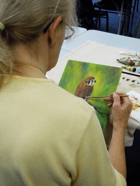 Rainy Lindell works on a painting at a meeting of the Island Artists in Coupeville.