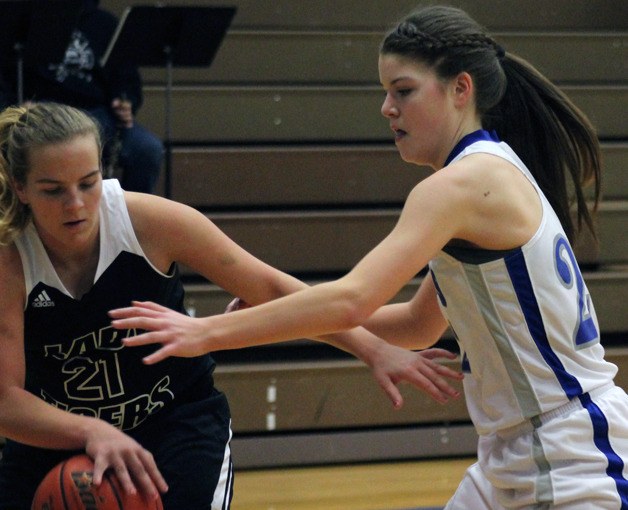 Falcon freshman Megan Drake tries to steal the ball from Granite Falls junior Annie Hart in the first quarter of a Cascade Conference game Friday night at South Whidbey High School. South Whidbey’s harassing defense stymied Granite Falls throughout the contest.