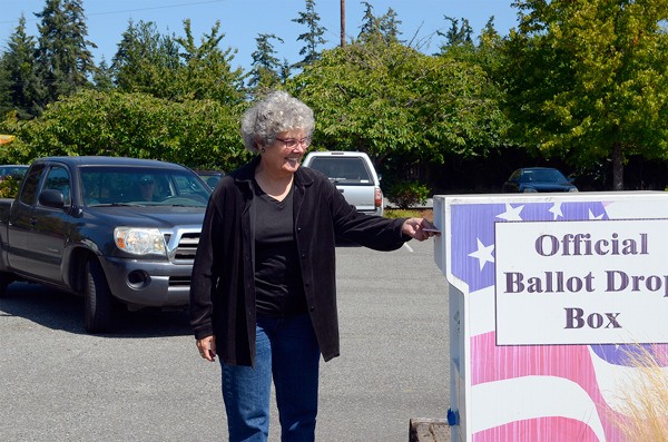 Freeland resident Brenda Tracy drops off her primary ballot Monday in Freeland. The first round of election results shows the Port of South Whidbey's fairgrounds measures are passing.