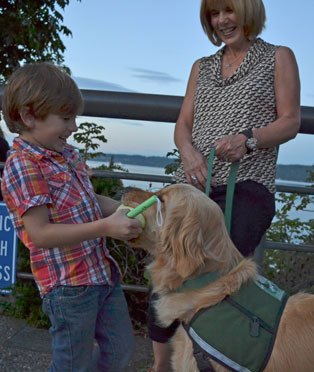 Max playfully pulls a ball from 5-year-old Hugh Evans