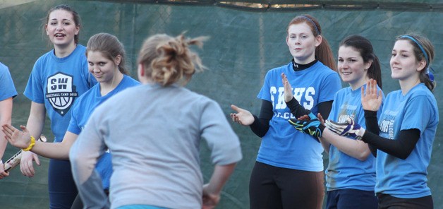 Falcon fastpitch players cheer on a teammate during a base running drill.