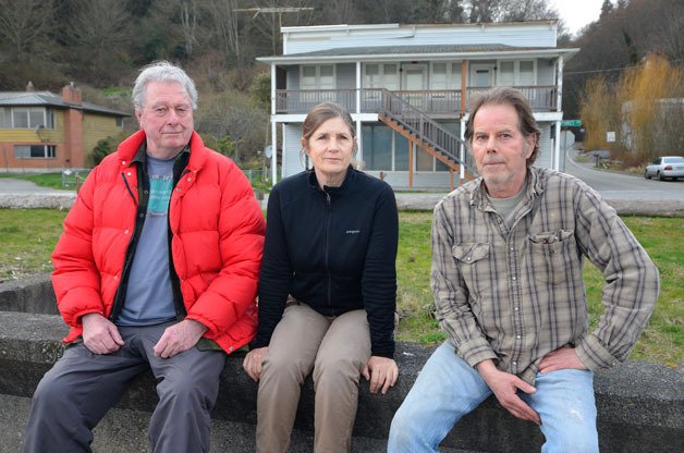 Glendale beach access proponents Mike McVay and Mindy and Mike Thompson sit on the breakwater in front of the old Glendale Hotel on South Whidbey. The Island County Commissioners this month decided not to consider purchasing the building