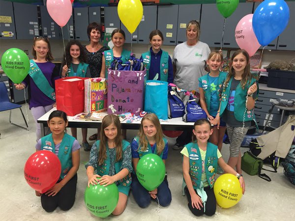 The South Whidbey fifth-grade Junior Girl Scout Troop 42183 earned a bronze award during a community service project with Kids First of Island County to help children entering foster care.