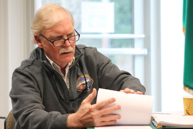South Whidbey Fire/EMS Chief Rusty Palmer looks through some paperwork about the estimated $5.4 million proposed new Bayview station Thursday evening.