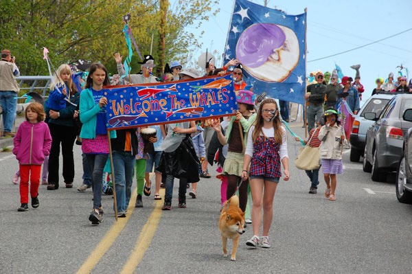 Children (and a dog) lead the way down First Street in Langley at the ninth annual Welcome to the Whales Day Parade and Festival Saturday afternoon. Organizers estimate that up to 1