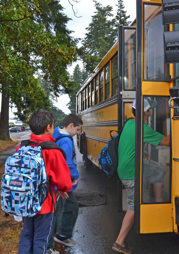 South Whidbey School District students load onto the bus on Camano Avenue for the first day of school Sept. 3.