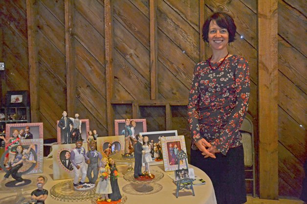 Valerie Heggenes presents her cake toppers during the Weddings on Whidbey and Events Tour on Saturday