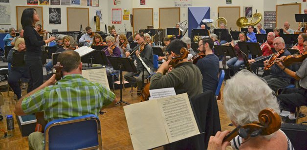 Julia Tai conducts the orchestra for the first time during rehearsal on Monday