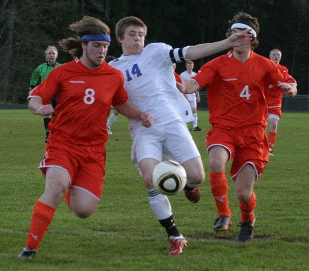 Pat Myatt gets a shot on goal past Granite Falls defenders Marshall Zenk (8) and Chris Hoeppner (4). South Whidbey’s senior co-captain scored four goals to keep the Falcons undefeated at 3-0.