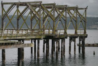 The derelict Hein dock at the Langley marina. Port of South Whidbey Commissioners rejected a Department of Natural Resources offer to remove the piers at the agency's expense Thursday morning.