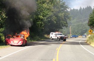 Fire consumes a Volkwagen Beetle on the side of Bayview Road