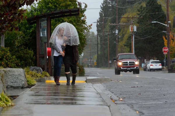 Mother and daughter Ada Rose Faith-Feyma and Sheila Weidendorf of Langley walk down Main Street in Freeland Friday for a cup of joe at WiFire Cafe. Others on South Whidbey were busy preparing for the coming storm