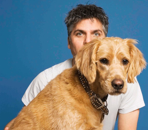 Garth Stein poses with a dog named Comet