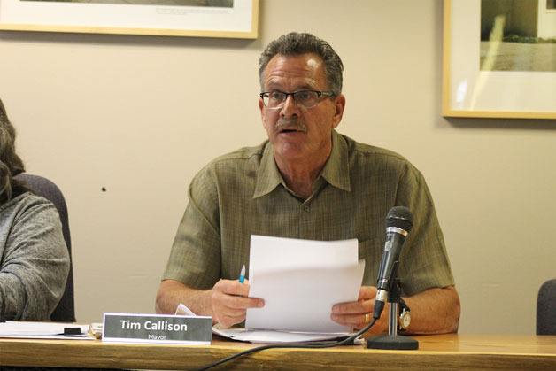 Langley Mayor Tim Callison explains the first-year sewer rate increases. The city council approved the increases for citizens at Tuesday night’s council meeting.