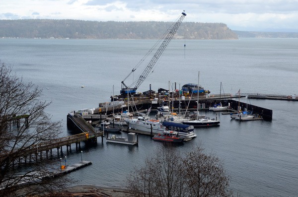 A crane is barged next to South Whidbey Harbor at Langley for work on outside mooring.