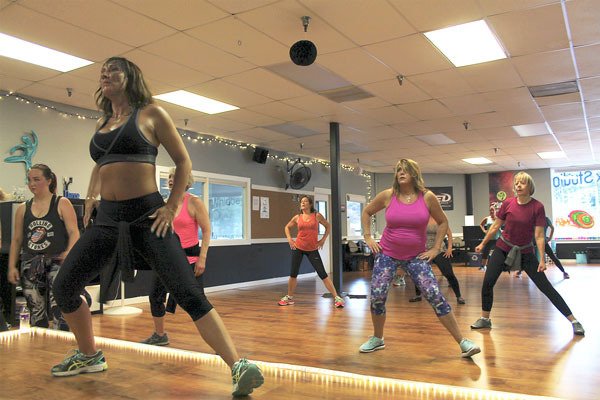 Whidbey Flex Studio owner Christine Lincks (front left) leads a group fitness class.