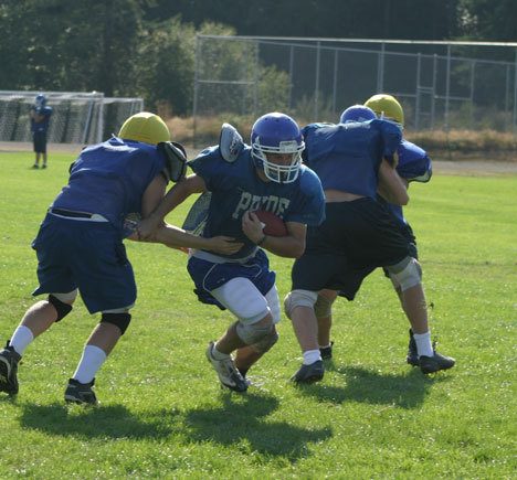 Falcon running back Henry “The Hank” Mead plows through his team’s defenders during a recent practice session. Despite the team’s 23-15 loss to Grandview in its first game